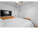 Bedroom with double door closet, light walls, and a flat screen television at 690 W 1St Ave, Broomfield, CO 80020