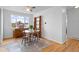 Bright dining room with hardwood floors, modern ceiling fan, and round glass table at 690 W 1St Ave, Broomfield, CO 80020