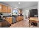 Updated kitchen featuring stainless steel appliances, wood cabinets, and tiled flooring at 690 W 1St Ave, Broomfield, CO 80020