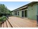 Wooden deck with stairs down to the yard and green siding at 2130 Chestnut Cir, Erie, CO 80516