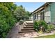Landscaped backyard with patio, flower beds, mature plants, and a stone walkway at 2130 Chestnut Cir, Erie, CO 80516
