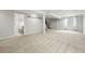 Large basement area with neutral carpeting, storage, and staircase to upper level at 2130 Chestnut Cir, Erie, CO 80516