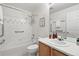 Cozy bathroom with tub, shower, and single sink vanity with decorative mirror at 2130 Chestnut Cir, Erie, CO 80516