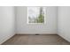 Bedroom with neutral carpet, white walls, and a large window for ample natural light at 2130 Chestnut Cir, Erie, CO 80516