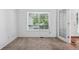 Cozy bedroom with plush carpet, a large window, and a glass panel door at 2130 Chestnut Cir, Erie, CO 80516