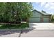 Charming two-story home with a well-manicured lawn, mature trees, and a three car garage at 2130 Chestnut Cir, Erie, CO 80516