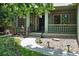 Inviting front porch with beautiful landscaping, garden lighting, and a walkway to the front door at 2130 Chestnut Cir, Erie, CO 80516