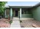 Inviting front porch with green trim, a black front door, and well-maintained landscaping at 2130 Chestnut Cir, Erie, CO 80516