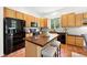 Well-lit kitchen with stainless steel appliances, light wood cabinets and a tiled floor at 2130 Chestnut Cir, Erie, CO 80516