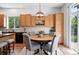 Bright kitchen features wood cabinetry, stainless steel appliances, and an eat-in breakfast nook at 2130 Chestnut Cir, Erie, CO 80516