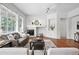 Bright living room featuring a cozy fireplace, hardwood floors, and comfortable seating at 2130 Chestnut Cir, Erie, CO 80516