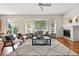 Bright and airy living room with large windows, a fireplace, and modern decor at 2130 Chestnut Cir, Erie, CO 80516