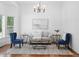 Inviting living room featuring stylish furniture, hardwood floors, and a modern chandelier at 2130 Chestnut Cir, Erie, CO 80516