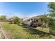 A sunny backyard featuring a deck and a large, grassy area perfect for outdoor activities and relaxation at 1488 S Andes Way, Aurora, CO 80017