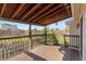 Wooden deck with a covered ceiling overlooking the backyard at 1488 S Andes Way, Aurora, CO 80017