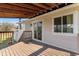 Wooden deck with covered ceiling and sliding glass door to the home at 1488 S Andes Way, Aurora, CO 80017