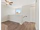 The hallway features modern décor, wood floors, and an abundance of natural light from the window at 1488 S Andes Way, Aurora, CO 80017