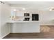 Bright kitchen boasts white cabinetry, sleek countertops, and stainless steel appliances at 1488 S Andes Way, Aurora, CO 80017