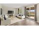 Bright living room showcasing modern furnishings, natural light, and access to a private outdoor deck at 1488 S Andes Way, Aurora, CO 80017