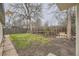 The backyard features a wood fence, grass and a tree at 1525 Roslyn St, Denver, CO 80220