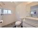 This remodeled bathroom features modern fixtures and black tile flooring at 1525 Roslyn St, Denver, CO 80220