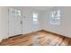 Bright bedroom with new hardwood flooring, fresh paint, new windows, and new door at 1525 Roslyn St, Denver, CO 80220