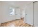 Bright bedroom features hardwood floors, a closet with sliding doors, and natural light at 1525 Roslyn St, Denver, CO 80220