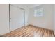 Bright bedroom featuring wood floors, closet with sliding doors, and natural light at 1525 Roslyn St, Denver, CO 80220