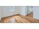 Bright bedroom with new hardwood flooring, fresh paint, and a large window at 1525 Roslyn St, Denver, CO 80220