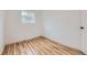 Clean, bright bedroom with wood flooring and lots of natural light from the window at 1525 Roslyn St, Denver, CO 80220