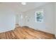 Bedroom featuring hardwood flooring, new windows, fresh paint, and an access door at 1525 Roslyn St, Denver, CO 80220