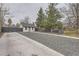 Exterior view of a single-story home featuring a large yard and privacy fence in a neighborhood setting at 1525 Roslyn St, Denver, CO 80220