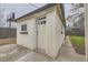 Exterior view of building with a concrete pad, a beige door, and an awning at 1525 Roslyn St, Denver, CO 80220