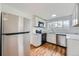 Updated kitchen with stainless steel refrigerator, microwave, and oven range at 1525 Roslyn St, Denver, CO 80220