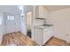 This kitchenette features white cabinets, granite countertops, and a stainless steel faucet at 1525 Roslyn St, Denver, CO 80220