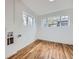 Bright room with hardwood flooring and new windows, offering versatility for various uses at 1525 Roslyn St, Denver, CO 80220