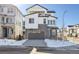 Two-story modern home with gray garage and snowy front yard at 8588 Eagle River St, Littleton, CO 80125