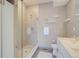 Modern bathroom with glass shower, floating shelves, and white vanity at 2426 Welton St, Denver, CO 80205