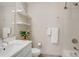 Modern bathroom features floating shelves, a shower, and clean, contemporary finishes at 2426 Welton St, Denver, CO 80205