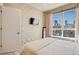 Comfortable bedroom with a TV mounted on the wall and city views at 2426 Welton St, Denver, CO 80205