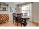 Inviting dining room features a dark wood table, modern accents, and natural light from a large window at 2426 Welton St, Denver, CO 80205