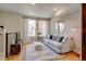 Cozy living room featuring a comfortable white sofa, modern decor, and abundant natural light from large windows at 2426 Welton St, Denver, CO 80205