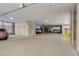 A large, open parking garage with ample parking spaces and concrete pillars and ceiling at 2426 Welton St, Denver, CO 80205