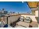 Stylish rooftop deck features outdoor seating and impressive city views at 2426 Welton St, Denver, CO 80205