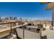 Stylish rooftop patio with city views, complete with comfortable seating around a modern fire pit feature at 2426 Welton St, Denver, CO 80205