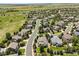An aerial view of a tranquil neighborhood with a winding street, lush green spaces, and serene views at 5309 Mining Camp Trl, Parker, CO 80134