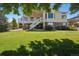 Expansive backyard with a well-maintained lawn and a multi-level deck at 5309 Mining Camp Trl, Parker, CO 80134