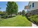 Side view of a beautifully landscaped backyard with lush green grass at 5309 Mining Camp Trl, Parker, CO 80134