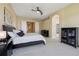Large bedroom featuring neutral carpet, a ceiling fan, and modern black furniture at 5309 Mining Camp Trl, Parker, CO 80134