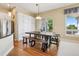 Bright dining area featuring hardwood floors, access to the outdoor patio, built in storage, and a modern table at 5309 Mining Camp Trl, Parker, CO 80134